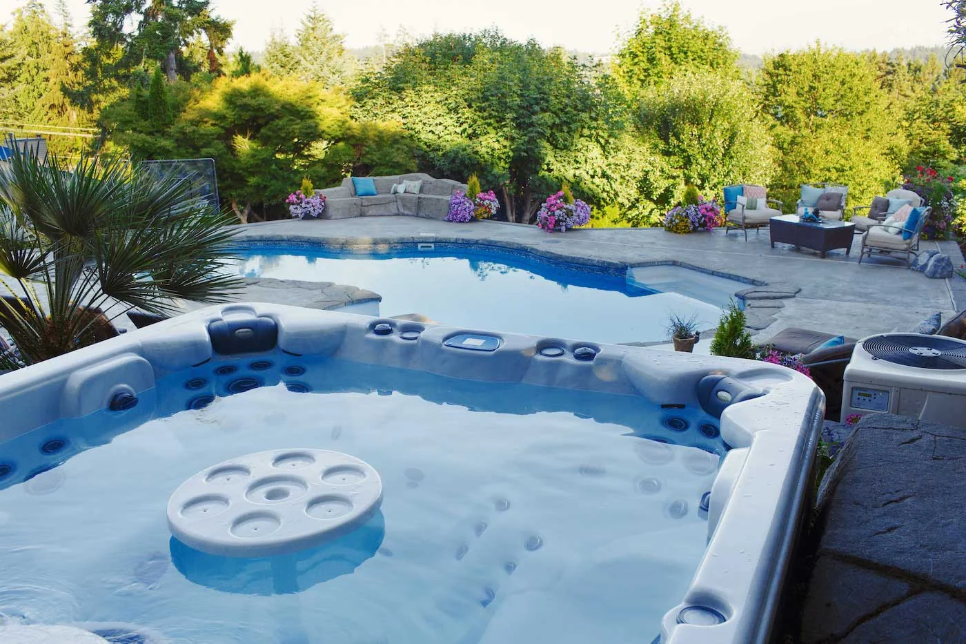 Clearwater Spa with drink holder and pool in landscaped backyard