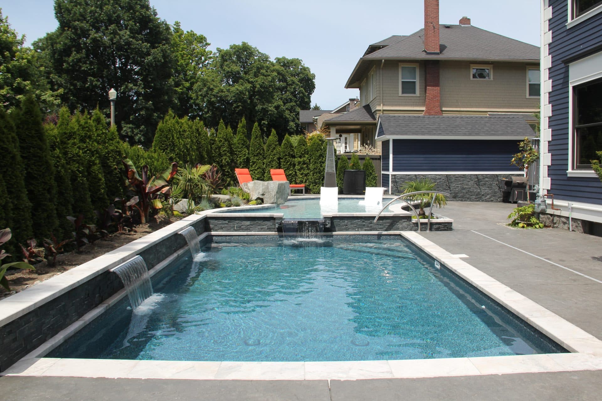 inground pool with spillover tanning ledge and waterfalls