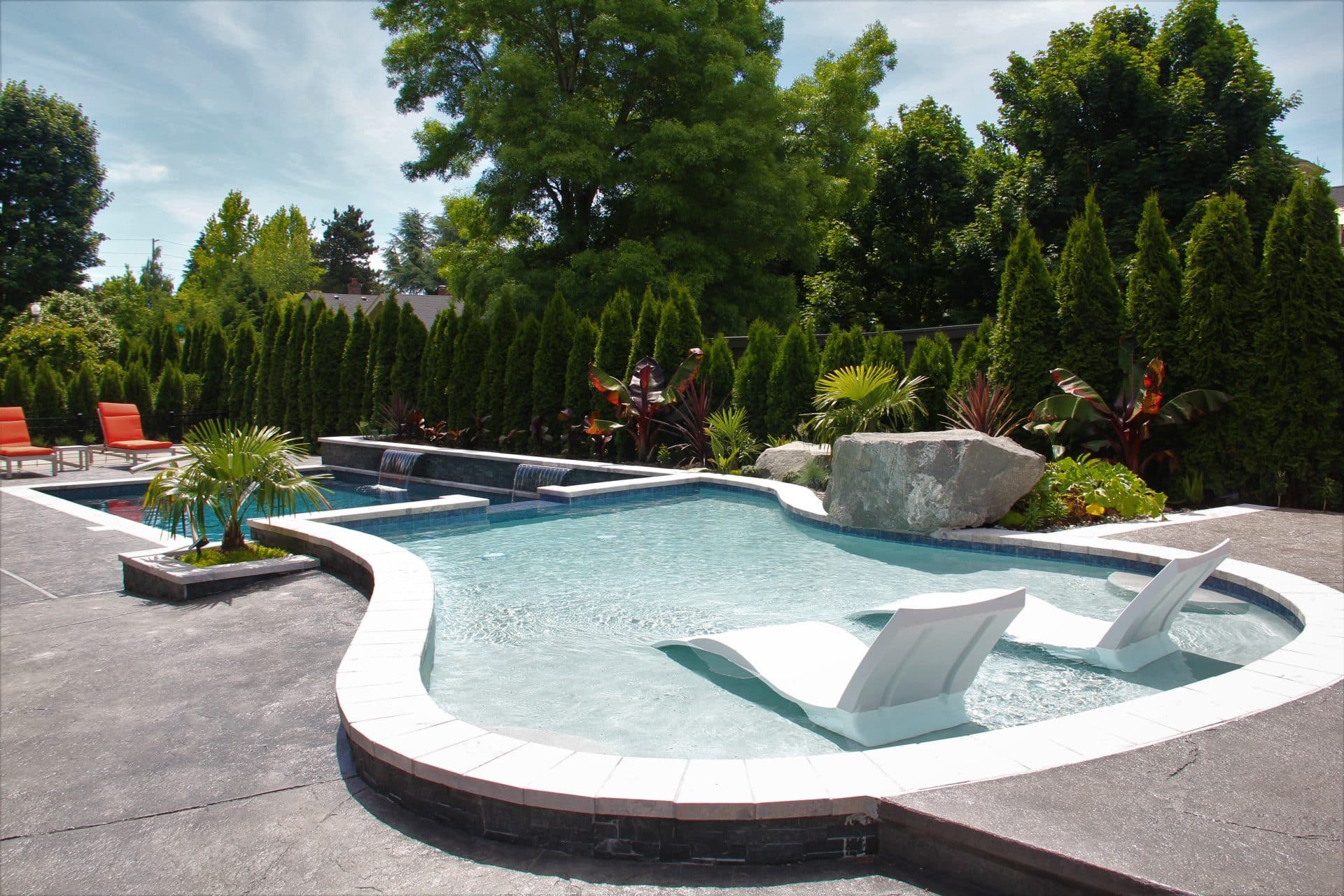 inground pool with spillover tanning ledge and waterfalls