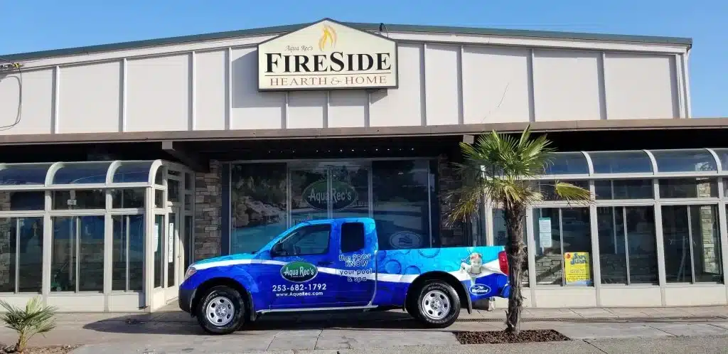 outside shot of aqua rec's fireside hearth n' home tacoma showroom with sales truck out in front