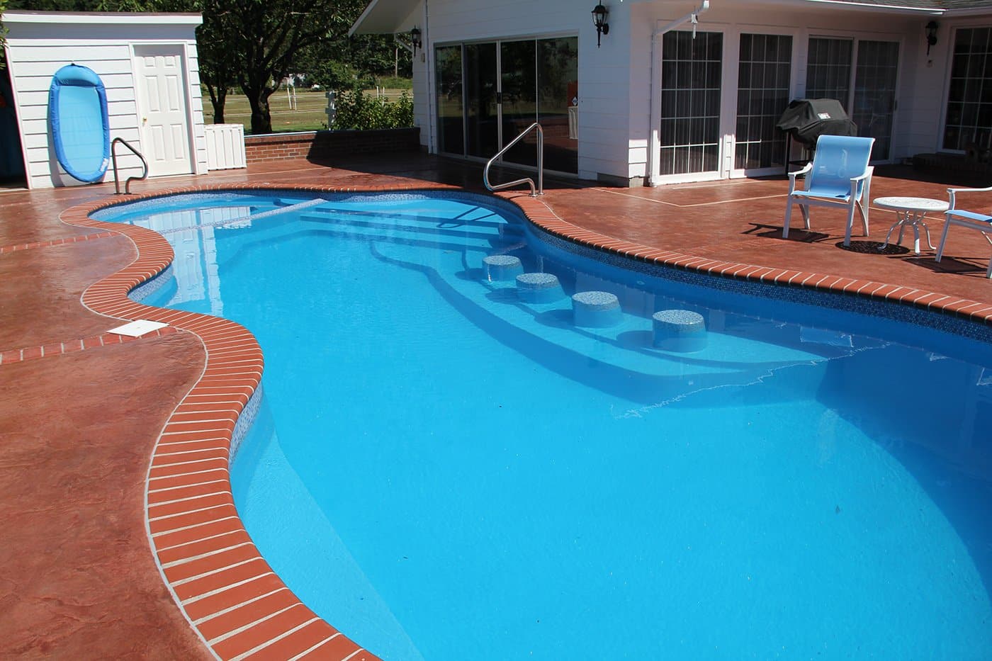 oasis pool with built-in seating and relaxing mini pool